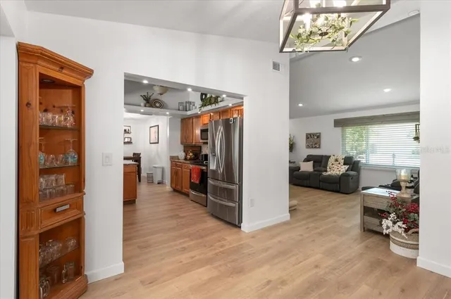 a kitchen with stainless steel appliances granite countertop a sink refrigerator stove and cabinets