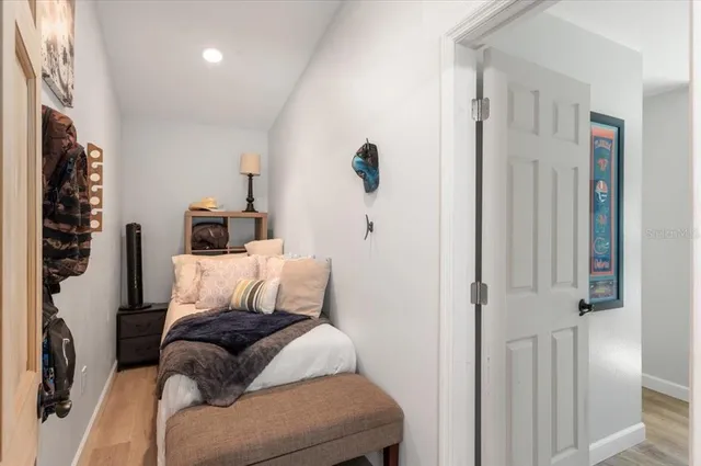 a bedroom with a bed and a chandelier