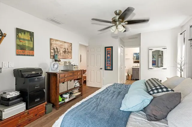 a en suite bathroom with a granite countertop sink and a mirror