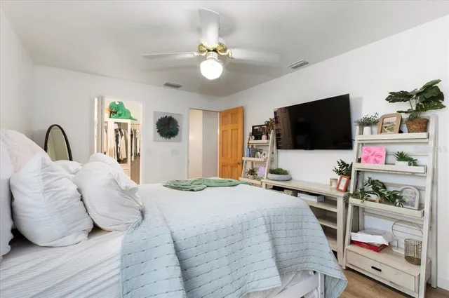 a bedroom with a bed and a chandelier