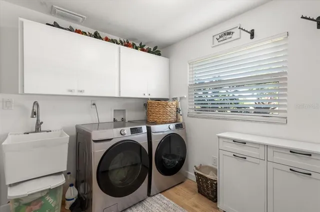 an aerial view of a house with swimming pool and large trees