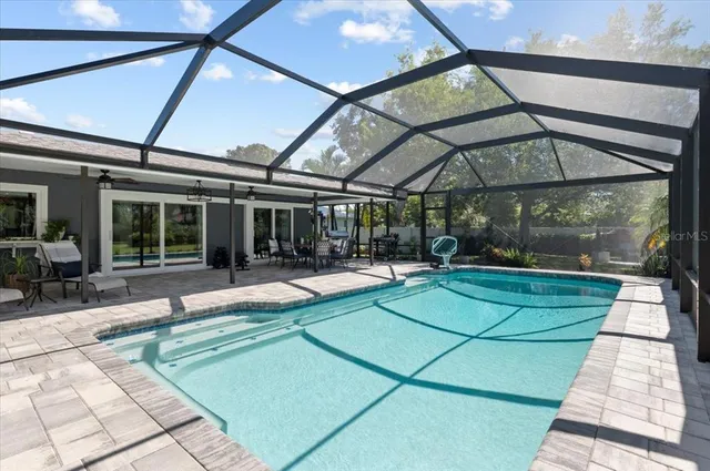 a view of a patio with a dining table and chairs under an umbrella