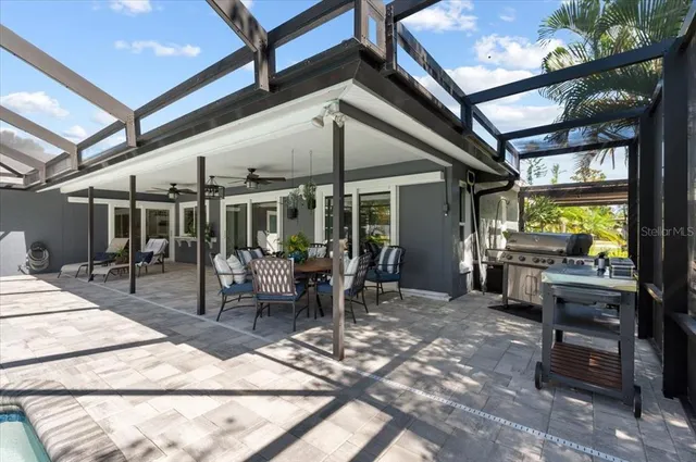 a outdoor space with chairs a stove and white kitchen