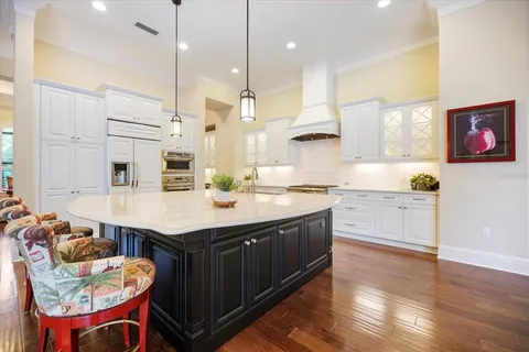 a kitchen with stainless steel appliances a stove and cabinets