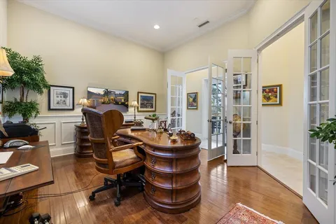 a bathroom with a granite countertop white vanity a a sink and a mirror