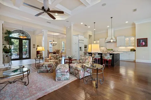 a kitchen with stainless steel appliances kitchen island granite countertop a table chairs and a refrigerator