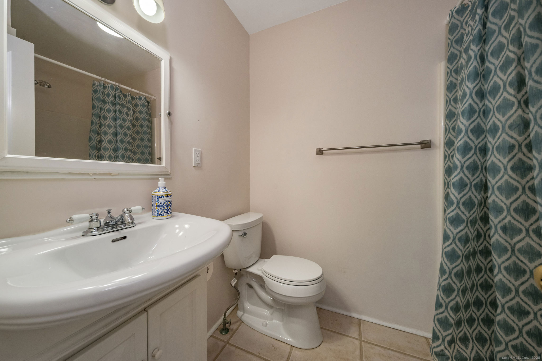 90 Boston Post Road Madison, CT 06443 - Photo 22 of 38 a bathroom with a sink a toilet and shower