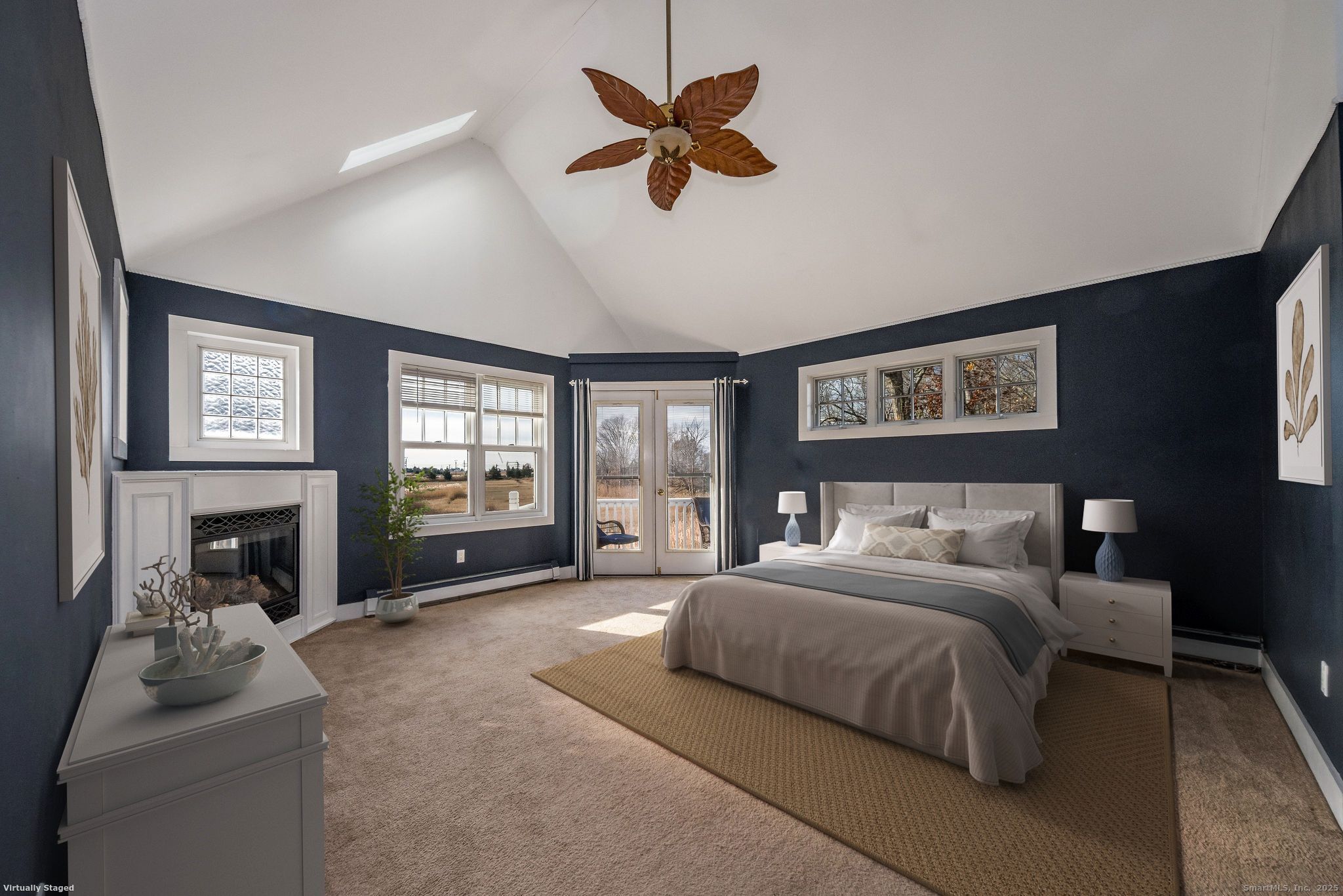 90 Boston Post Road Madison, CT 06443 - Photo 23 of 38 a spacious bedroom with a bed a couch and a fireplace