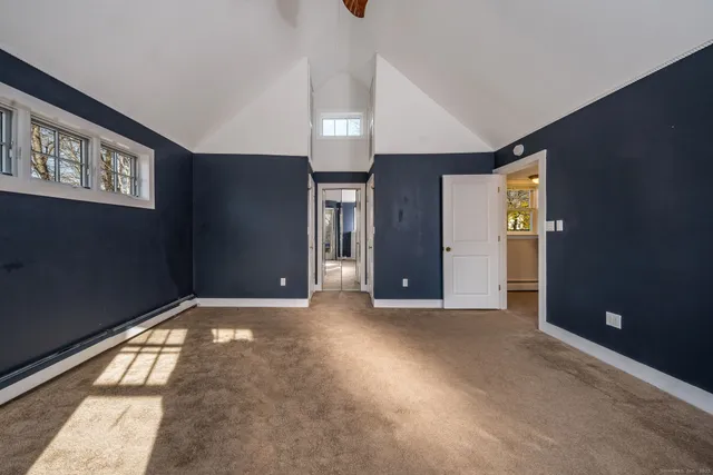 a view of an empty room with window and stairs