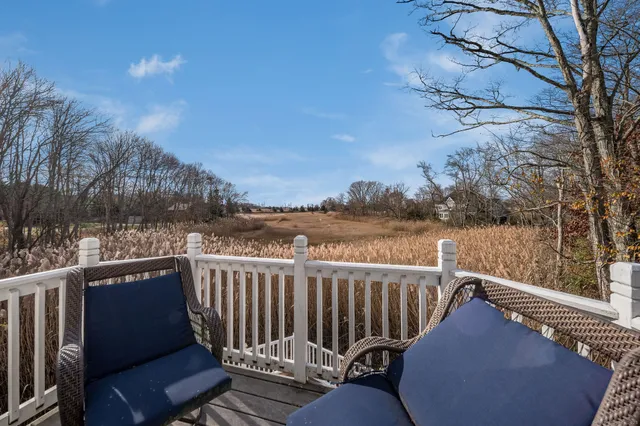 a view of roof deck with mountain and wooden fence