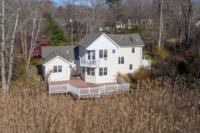 a white house with a white roof and a yard