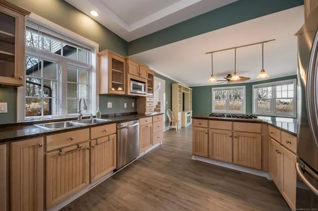 a kitchen with stainless steel appliances granite countertop a stove and cabinets