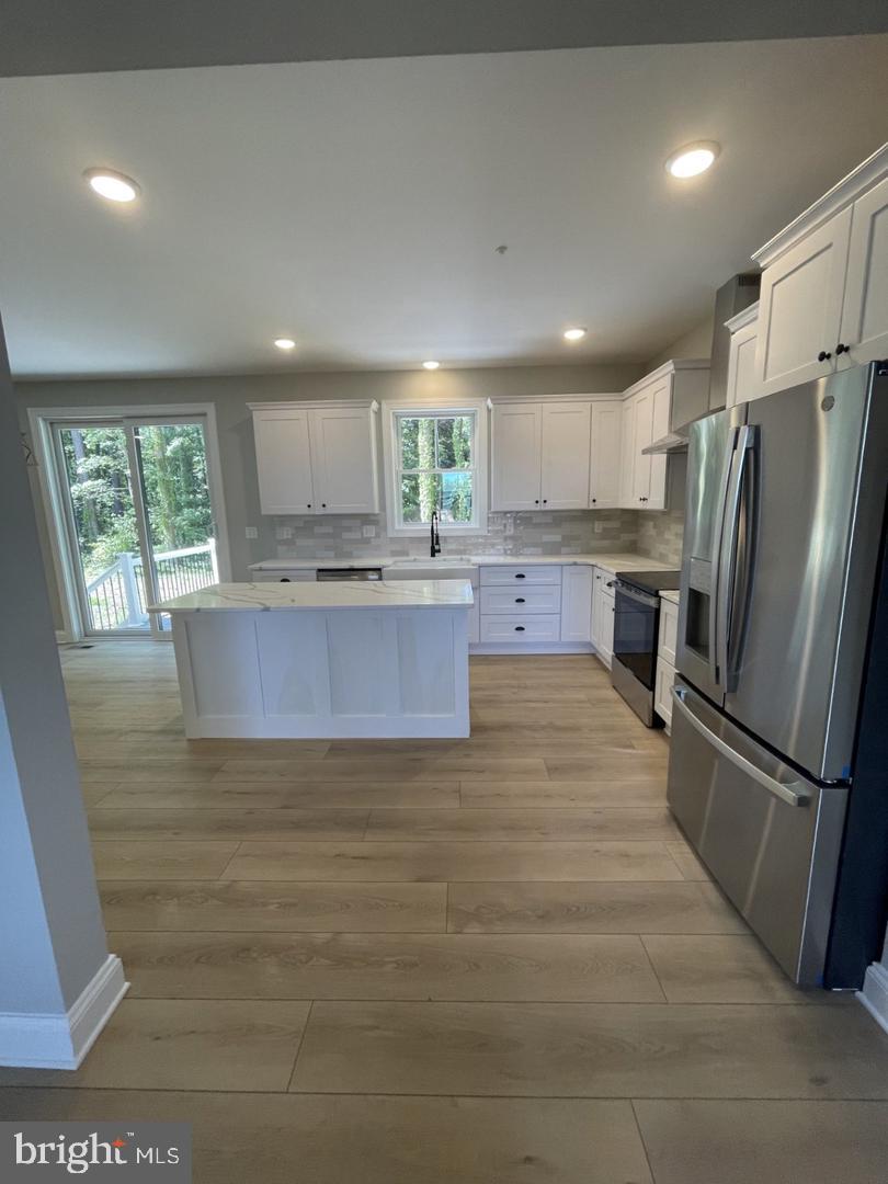 Queens Colony High Road Stevensville, MD 21666 - Photo 4 of 26 Gleaming white cabintes and stainless appliances.