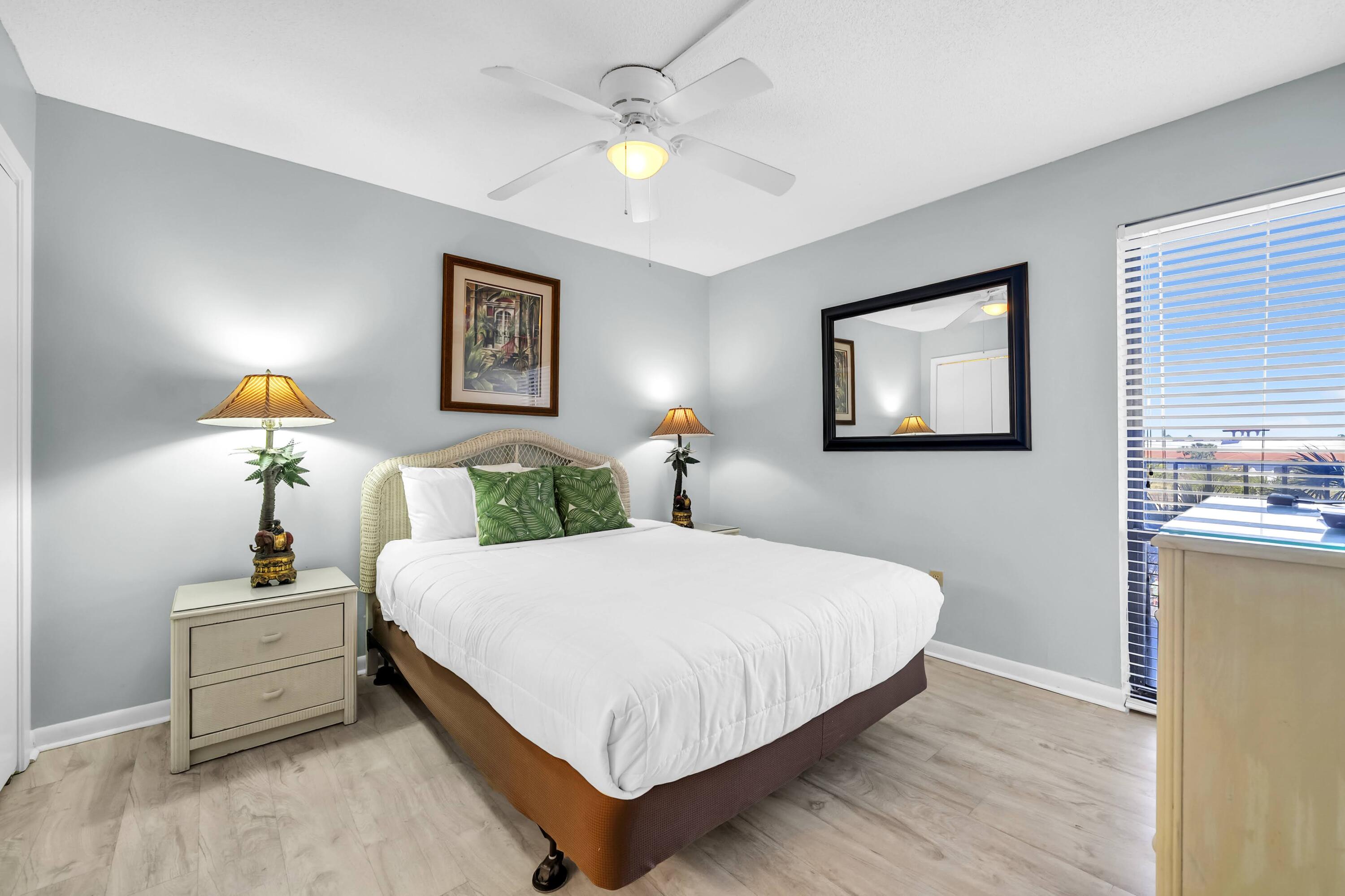 11619 Front Beach Road, Unit 307 Panama City Beach, FL 32407 - Photo 13 of 48 a bedroom with a bed and a chandelier