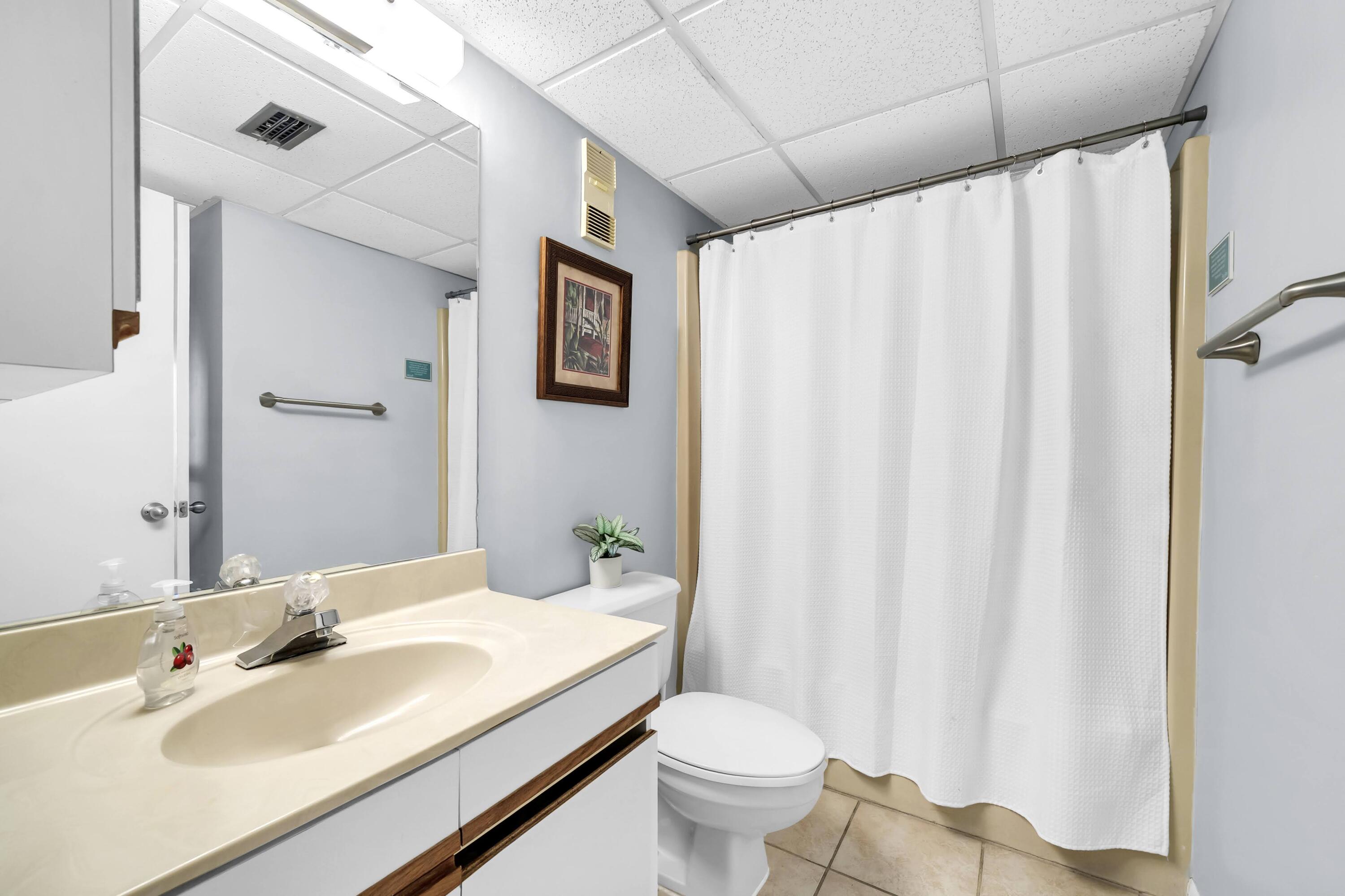 11619 Front Beach Road, Unit 307 Panama City Beach, FL 32407 - Photo 16 of 48 a bathroom with a sink and toilet