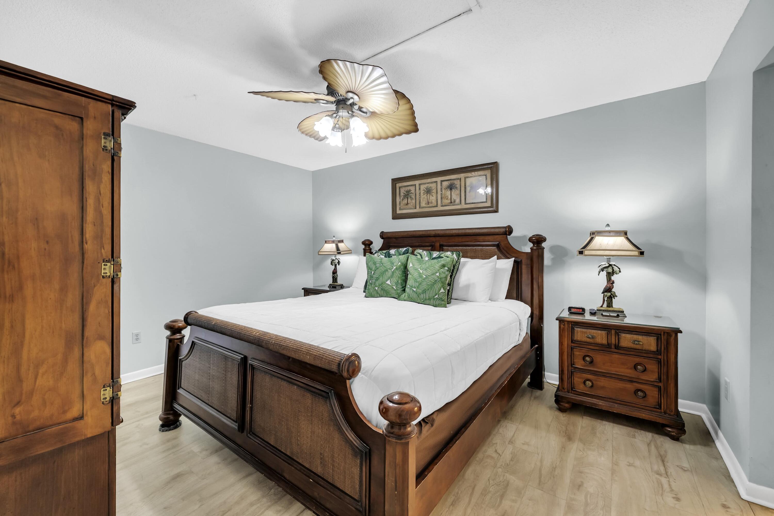 11619 Front Beach Road, Unit 307 Panama City Beach, FL 32407 - Photo 17 of 48 a spacious bedroom with a bed and a chandelier