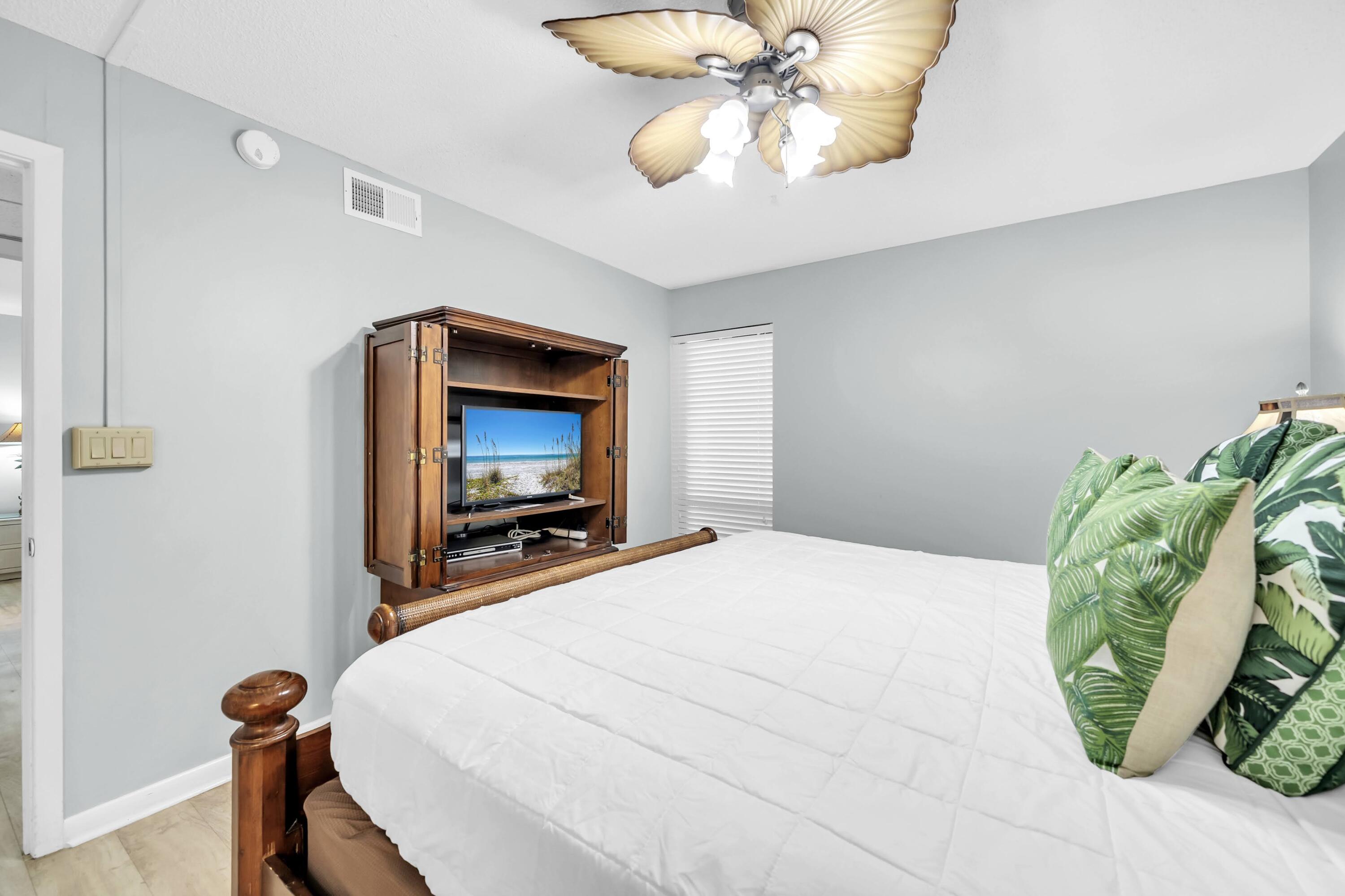 11619 Front Beach Road, Unit 307 Panama City Beach, FL 32407 - Photo 18 of 48 a bedroom with a bed and a chandelier
