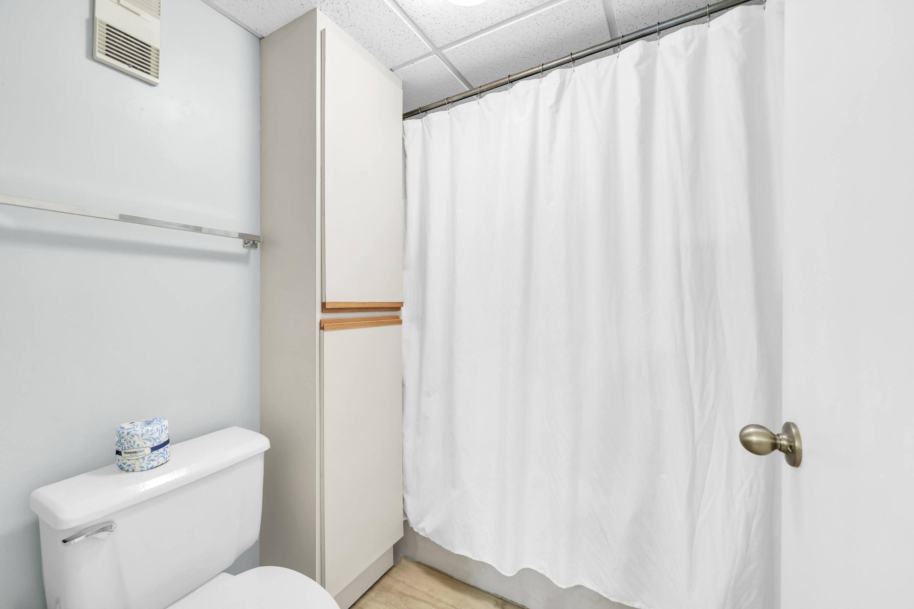 11619 Front Beach Road, Unit 307 Panama City Beach, FL 32407 - Photo 20 of 48 a white toilet sitting next to a white sink