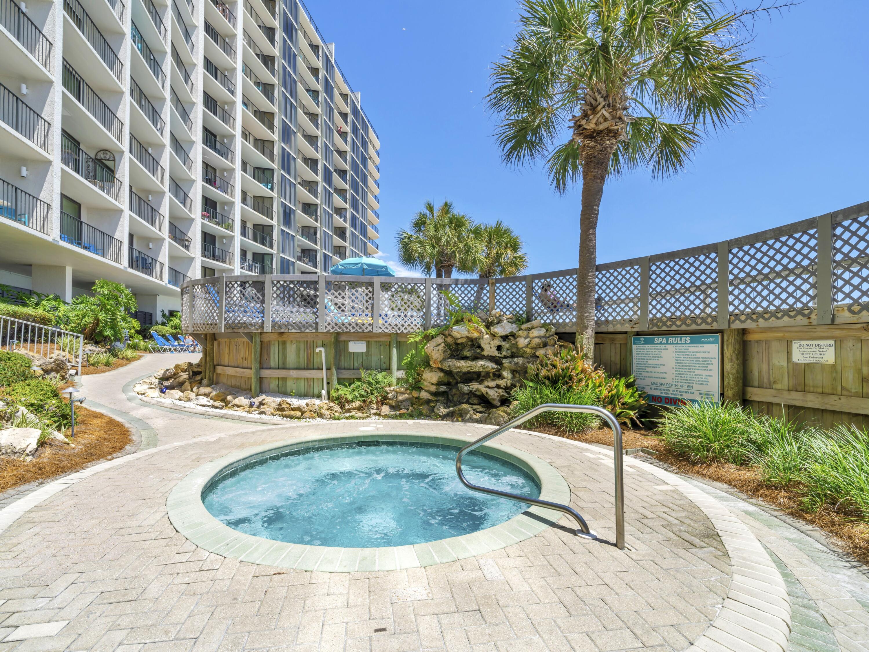 11619 Front Beach Road, Unit 307 Panama City Beach, FL 32407 - Photo 26 of 48 a view of a swimming pool with a house and a garden