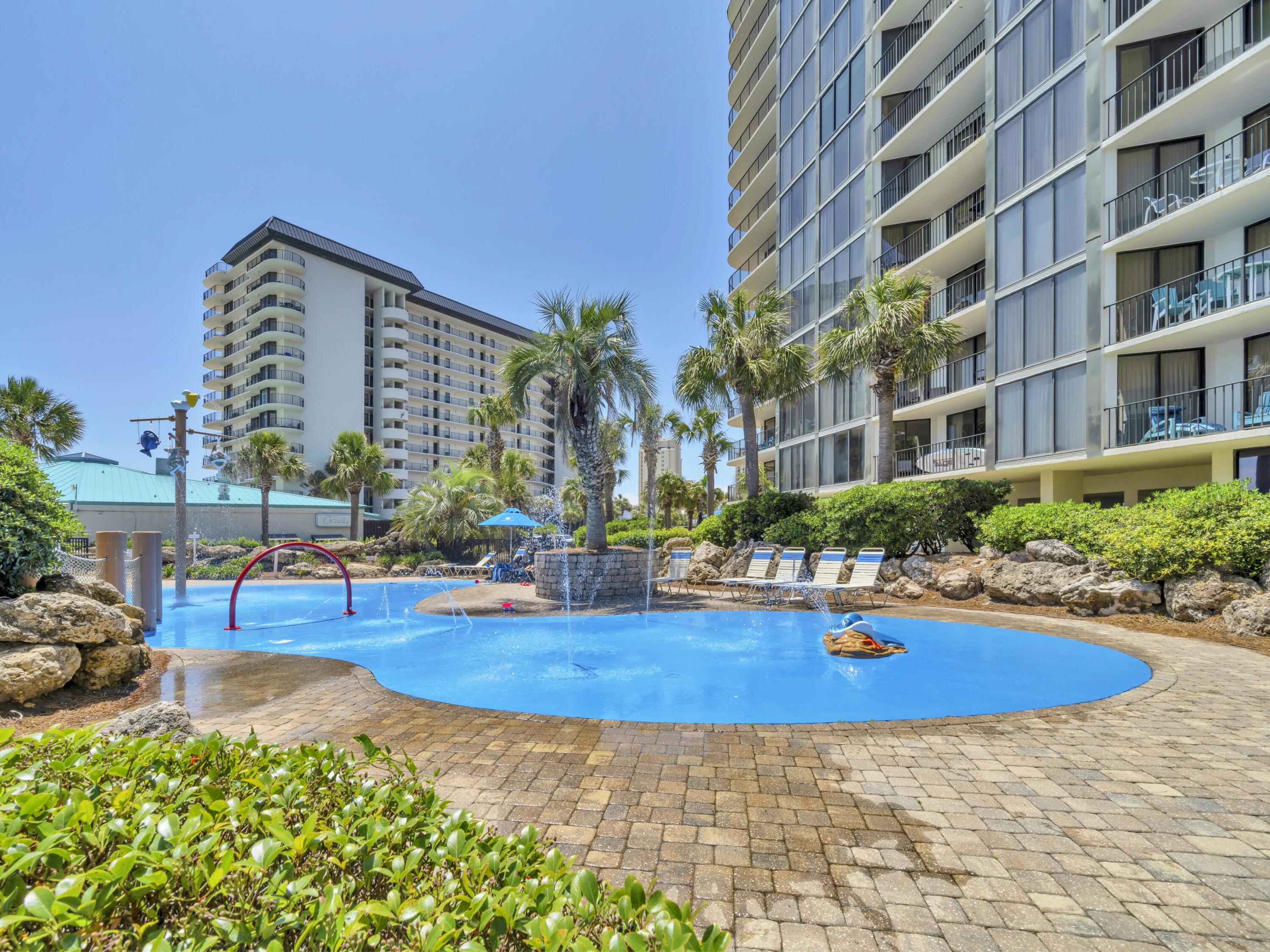 11619 Front Beach Road, Unit 307 Panama City Beach, FL 32407 - Photo 30 of 48 a view of swimming pool with outdoor seating and plants