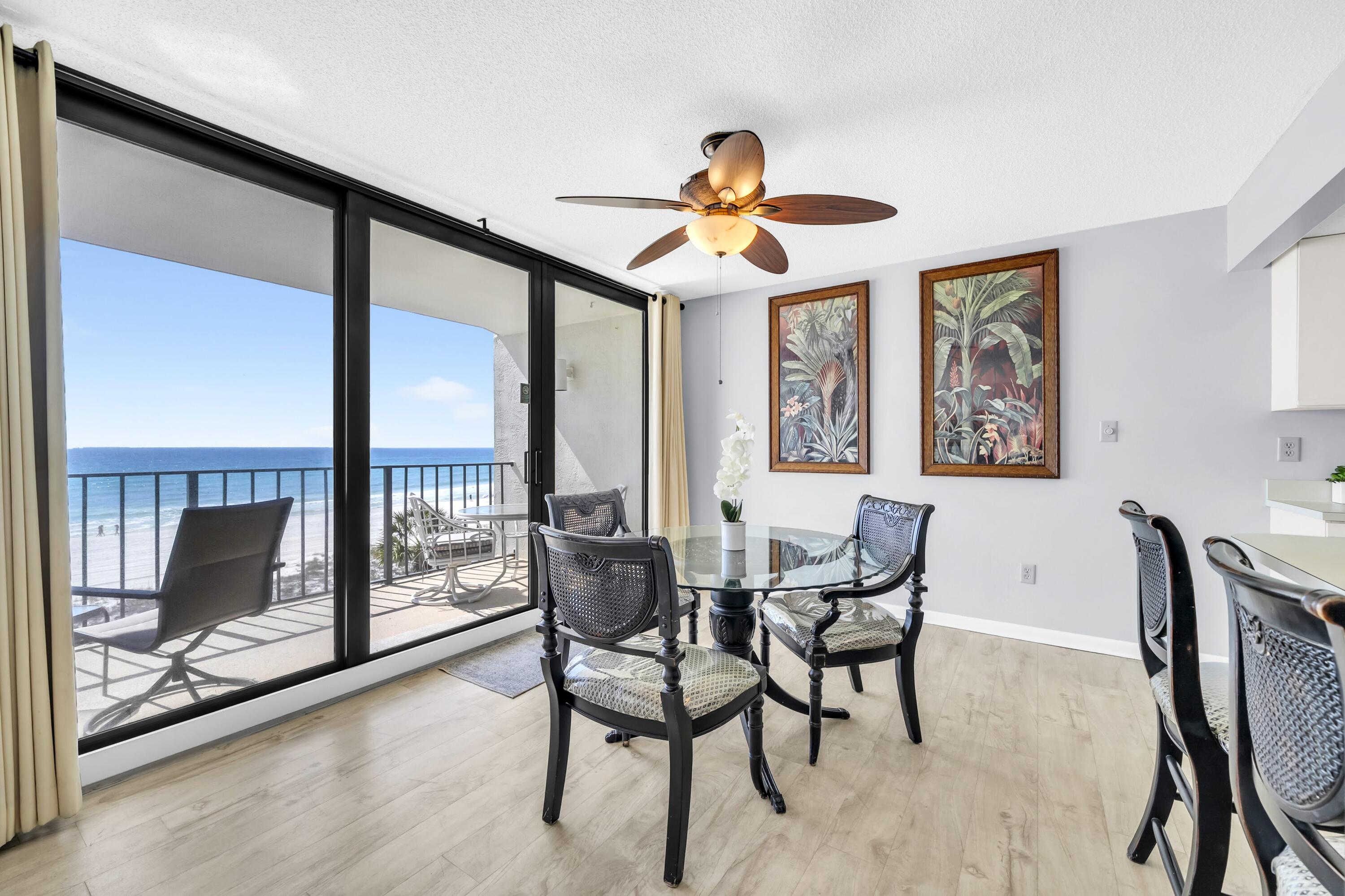 11619 Front Beach Road, Unit 307 Panama City Beach, FL 32407 - Photo 4 of 48 a dining room with furniture and a floor to ceiling window