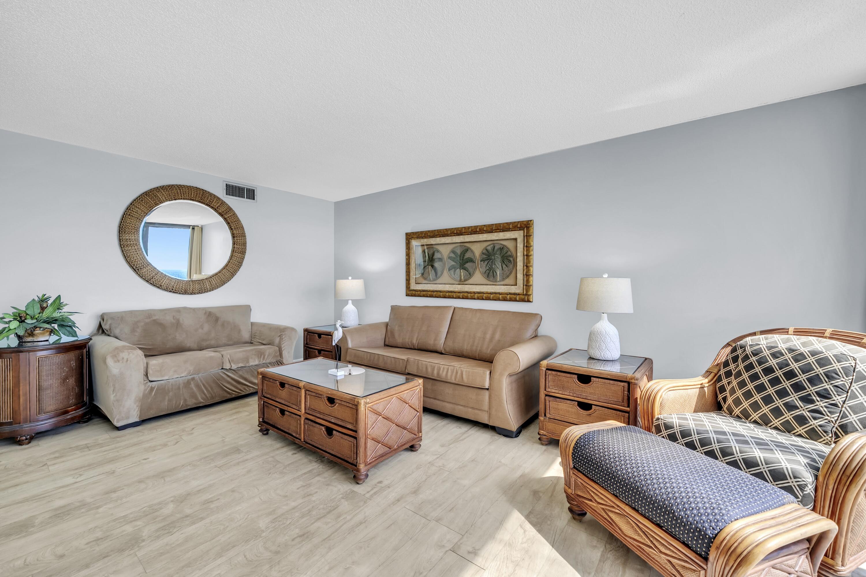 11619 Front Beach Road, Unit 307 Panama City Beach, FL 32407 - Photo 6 of 48 a living room with furniture and a lamp