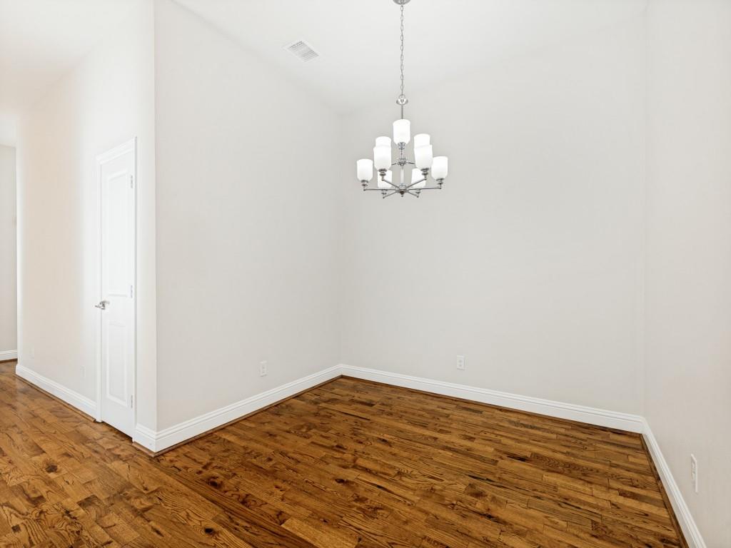 4010 Rive Lane Addison, TX 75001 - Photo 16 of 25 a view of a room with wooden floor and chandelier