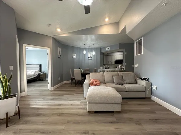 a living room with furniture and a wooden floor