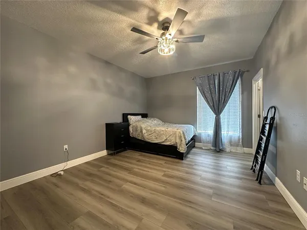 a bedroom with a bed and a chandelier