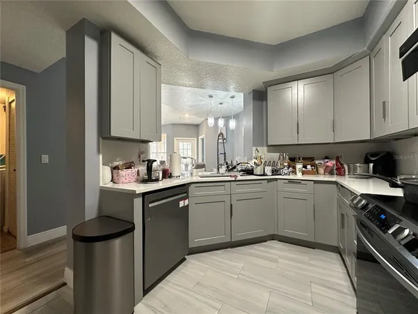 a kitchen with a sink cabinets and stainless steel appliances