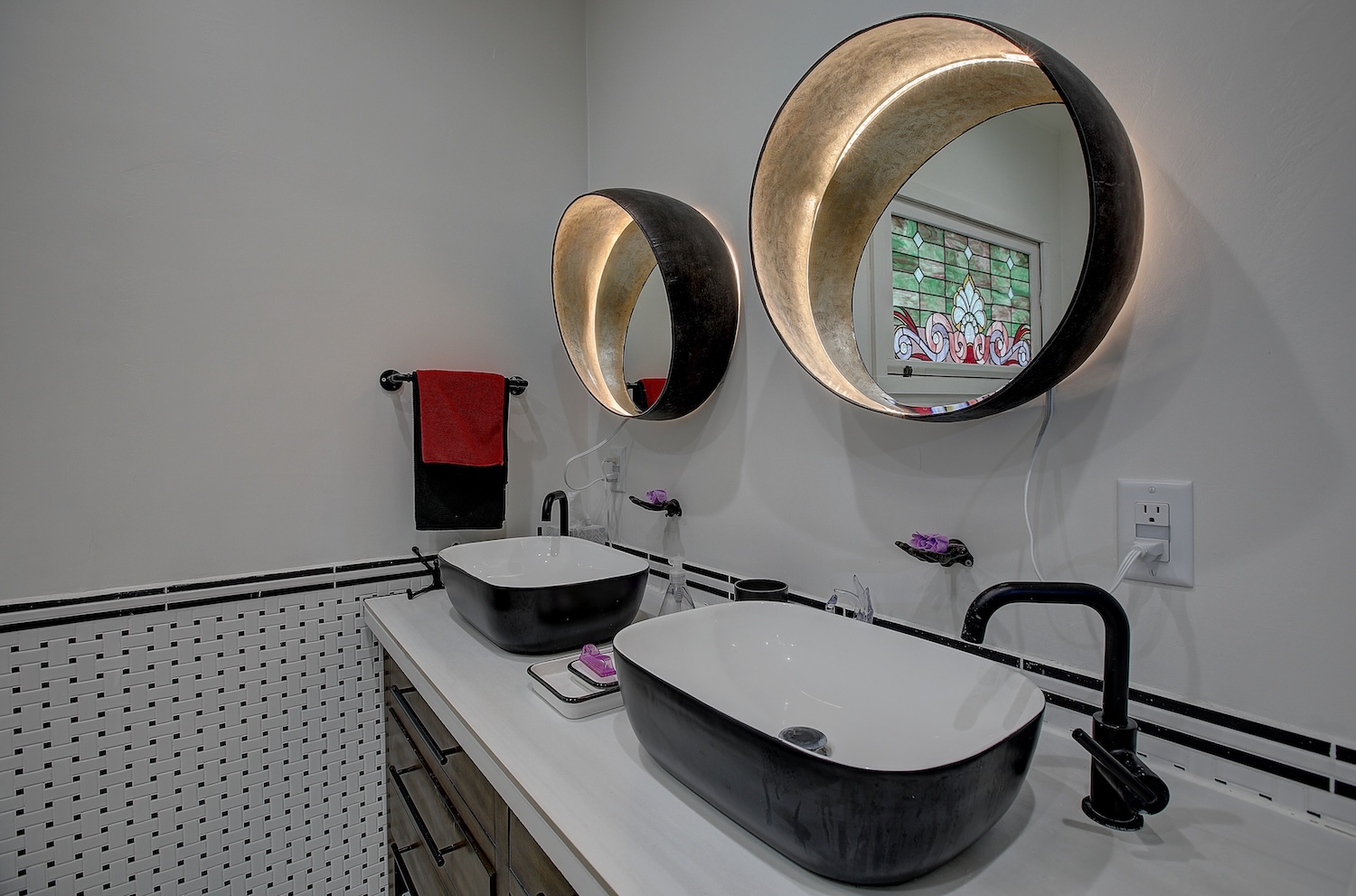 1903 South Austin Avenue Georgetown, TX 78626 - Photo 27 of 40 This beautiful updated bathroom has dual vanities, gorgeous period correct black and white tile, a diving soaking tub, and a glass enclosed walk in shower with multi head shower. Notice the stained glass window that matches the doors in the hall. If you end your day with a bath or start your day with a shower this space with make every day special.