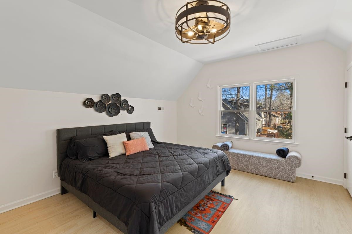 2718 Omah Street Durham, NC 27705 - Photo 19 of 20 a bedroom with a bed and a painting on the wall