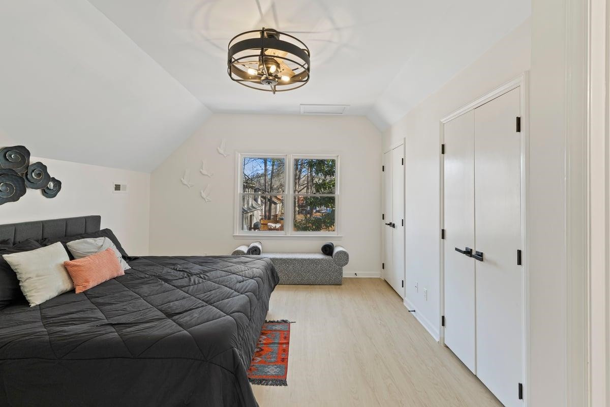 2718 Omah Street Durham, NC 27705 - Photo 20 of 20 a bedroom with a bed and a chandelier