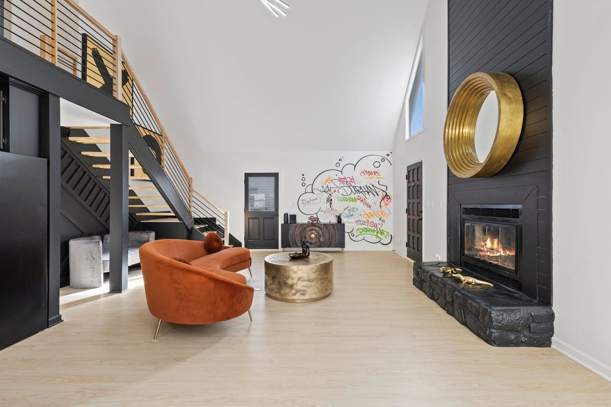 2718 Omah Street Durham, NC 27705 - Photo 7 of 20 a living room with fireplace furniture and a wooden floor