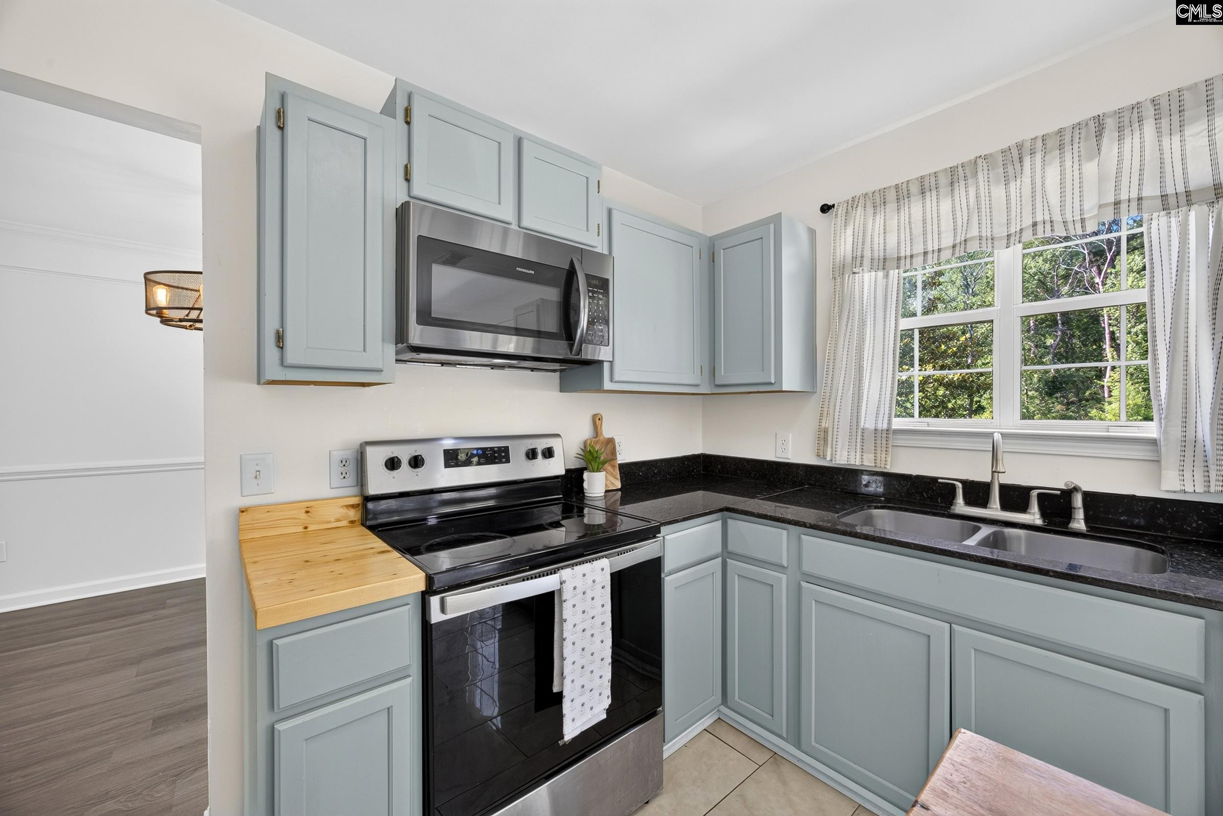 407 Sesqui Trail Columbia, SC 29223 - Photo 14 of 34 a kitchen with granite countertop a sink a stove and microwave