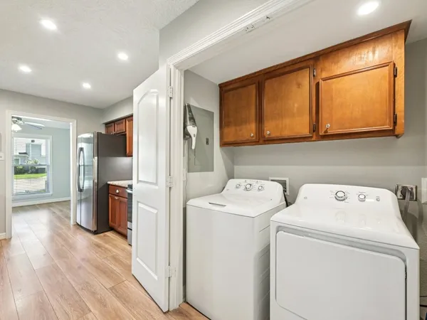 a view of washer and dryer with wooden floor