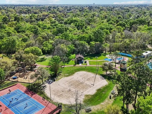 an aerial view of a house with yard basket ball court and outdoor seating