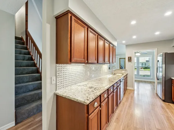 wooden floor in an empty room with a kitchen