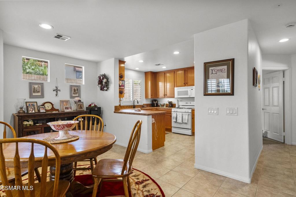 2046 Freesia Avenue Simi Valley, CA 93063 - Photo 14 of 37 a view of a dining room with furniture and wooden floor