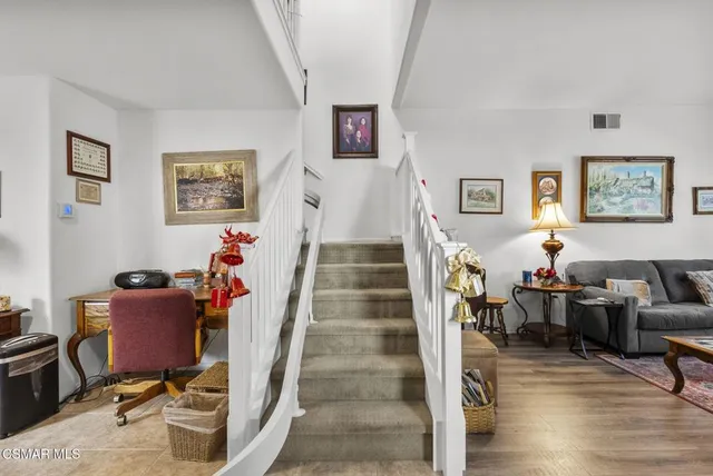 a view of a livingroom with furniture and workspace