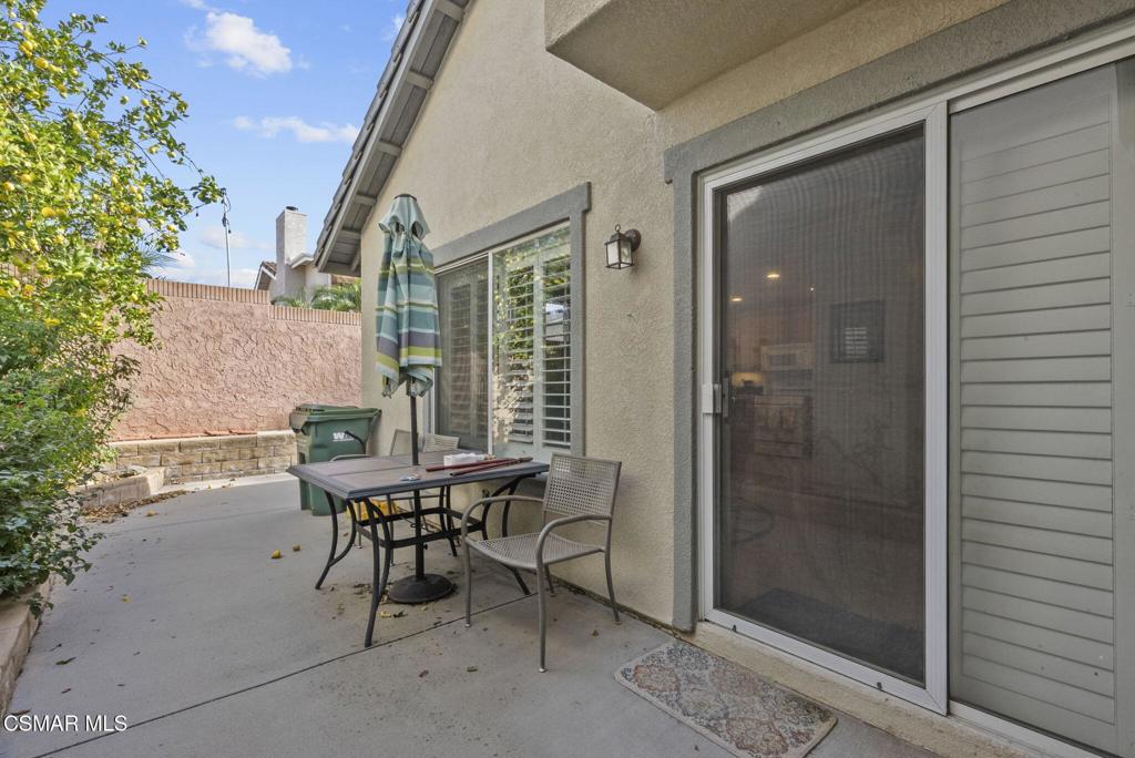 2046 Freesia Avenue Simi Valley, CA 93063 - Photo 31 of 37 a patio with table and chairs and potted plants
