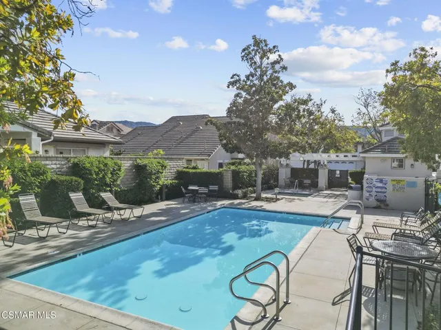 a view of a patio with table and chairs under an umbrella
