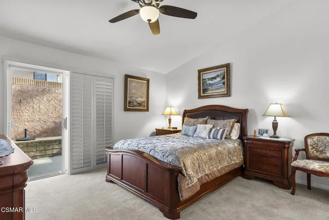 a bedroom with a bed couch and window