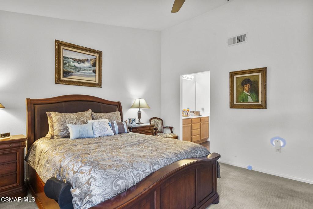 2046 Freesia Avenue Simi Valley, CA 93063 - Photo 7 of 37 a bedroom with a large bed and a lamp on table