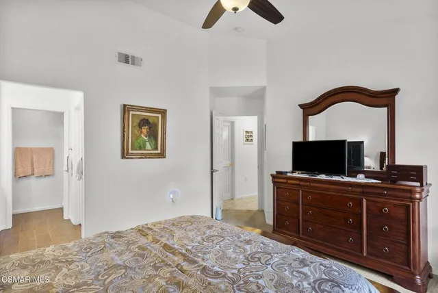 a bedroom with a bed and a television