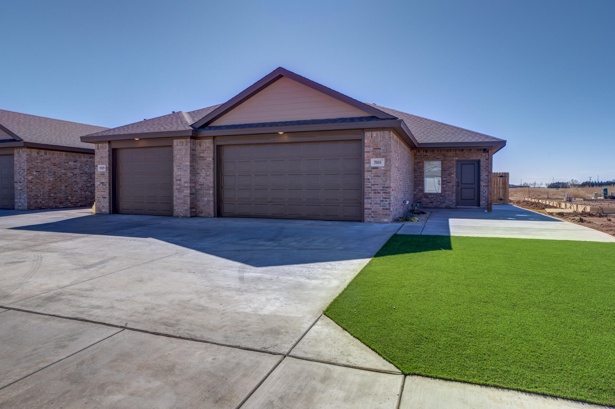 7011 40th Street Lubbock, TX 79407 - Photo 1 of 32 a front view of a house with a yard and garage