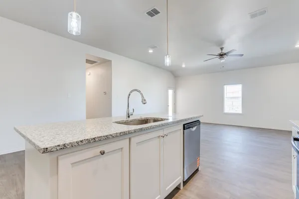 a kitchen with a sink and a refrigerator