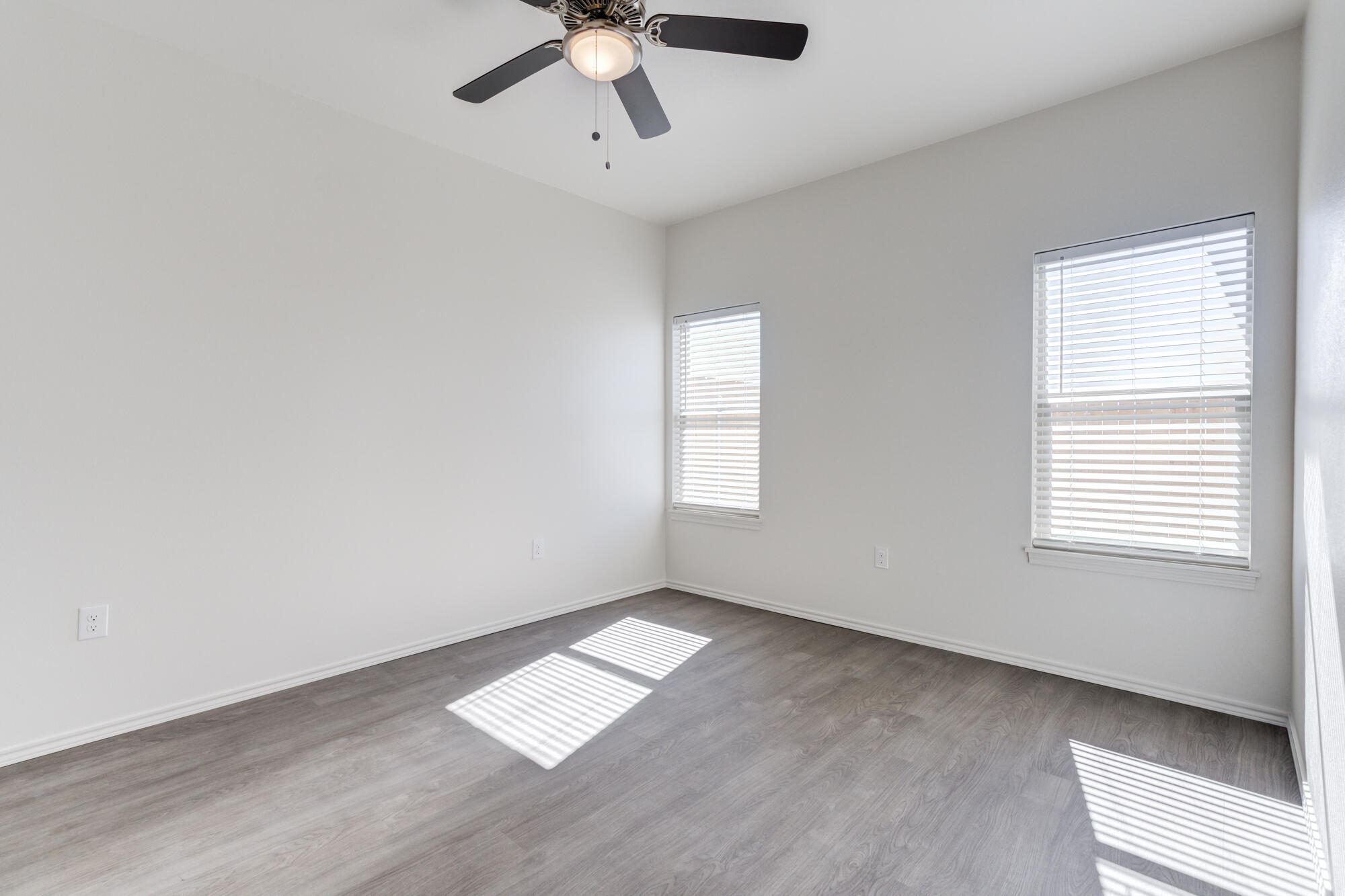 7011 40th Street Lubbock, TX 79407 - Photo 25 of 32 wooden floor in an empty room with a window
