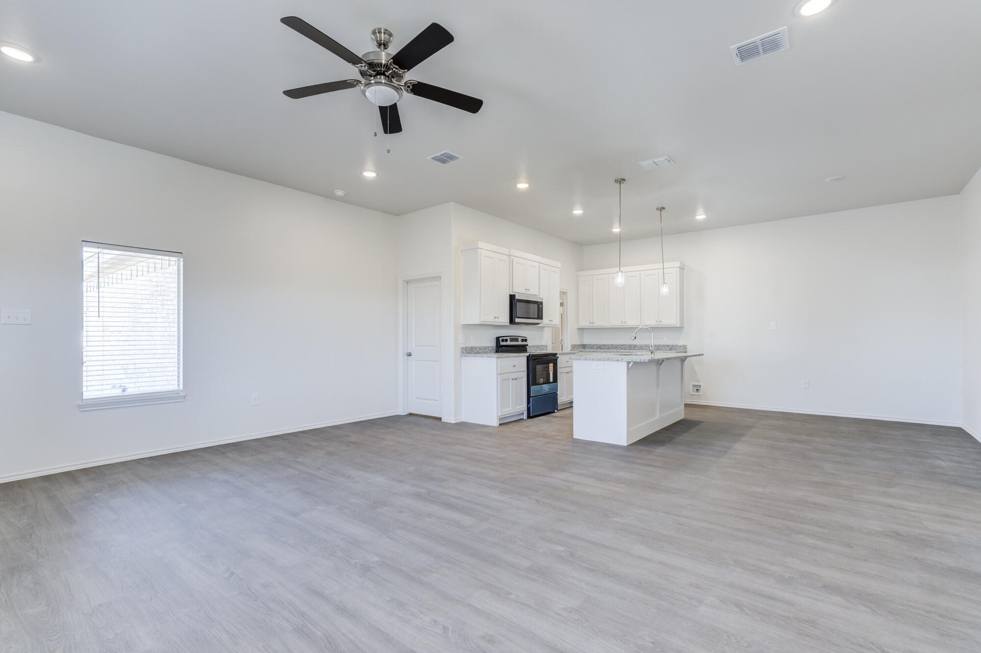 7011 40th Street Lubbock, TX 79407 - Photo 7 of 32 a view of kitchen with a sink stainless steel appliances and window