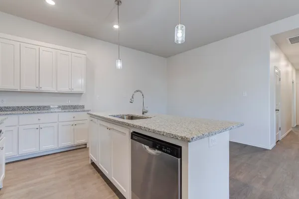a kitchen with a sink and cabinets